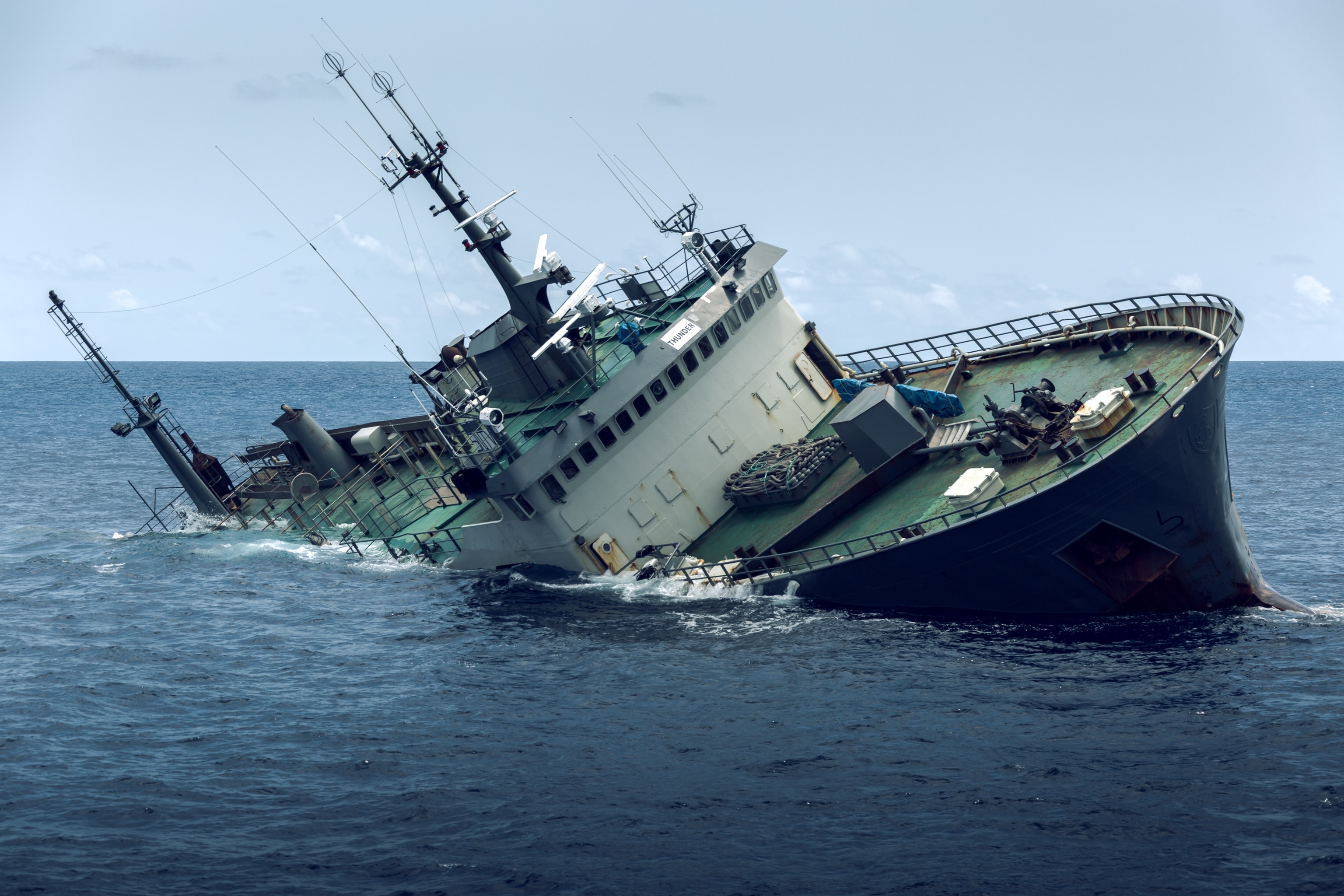A ship partially submerged in water.