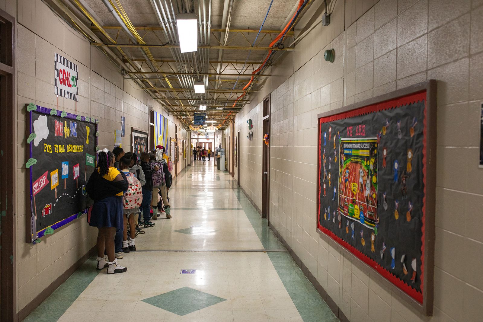 A hallway at the school is lined with posters about testing.