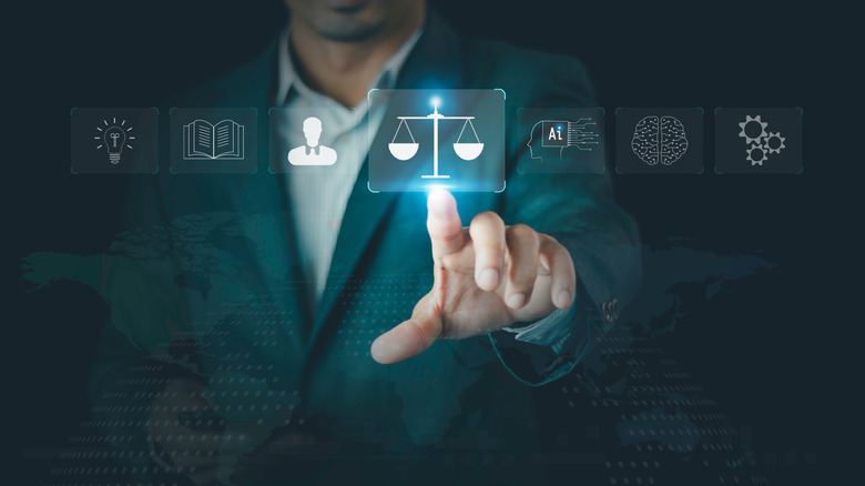 person pointing to a virtual icon of the scales