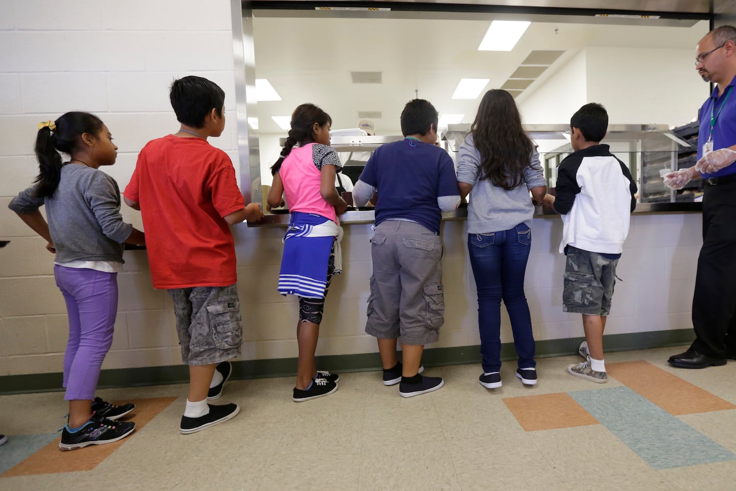Detained immigrant children lined up in the cafeteria at the Karnes County Residential Center, a detention center for immigrant families in Karnes City, Texas.